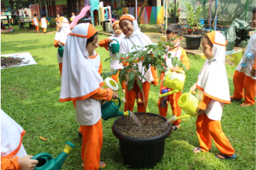 Children planting a tree in a garden